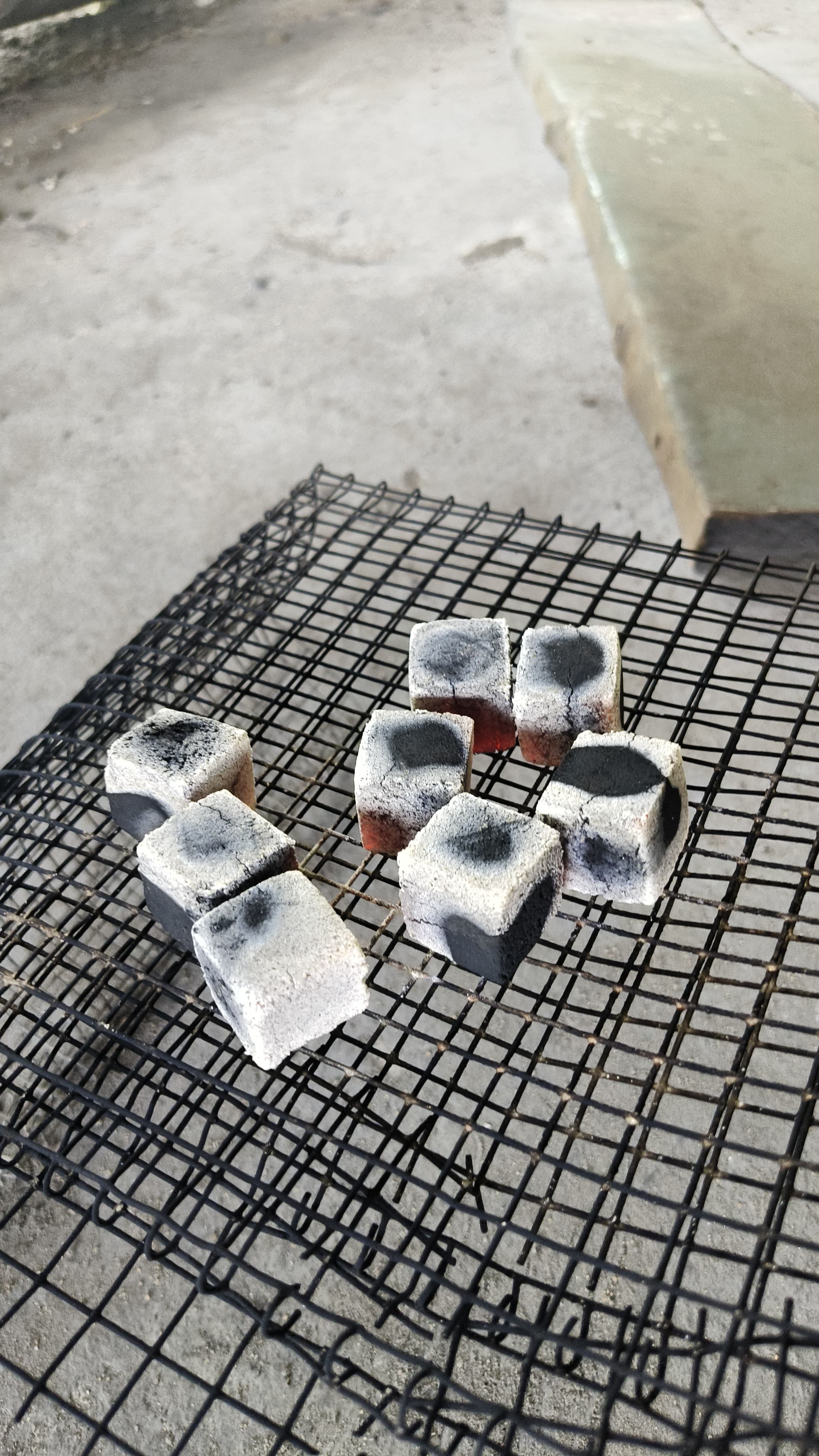 Coconut-shell charcoal briquettes being tested on a real supplied process grill.